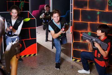Fototapeta na wymiar Kids playing laser tag on labyrinth