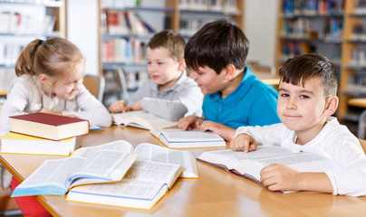 Fototapeta na wymiar Children studying in school library