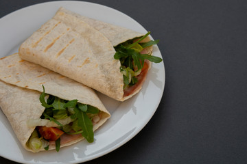 Healthy avocado and vegetables burrito, wraps, rolles. Healthy breakfast or snack. Avocado sandwich. Copy space.
