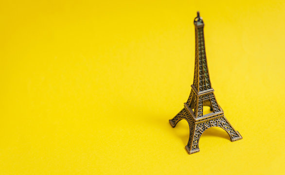 photo of Eiffel Tower shaped souvenir on the wonderful yellow studio background