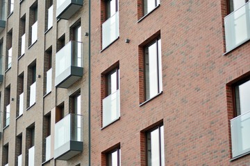 Naklejka premium Fragment of a modern apartment building in front. Very modern apartment house.