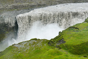 Dettifoss waterfall with bright green grass, Iceland