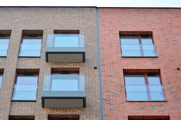 Obraz premium Fragment of a modern apartment building in front. Very modern apartment house.