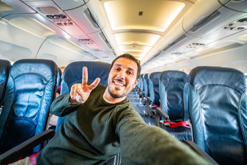 alone man taking selfie in the airport before flight with airplane