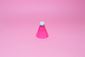 Pink badminton shuttlecock   isolated on the pink background. Concept sport , play, teamwork, motivation, attitude
