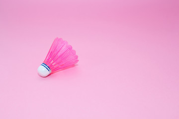 Pink badminton shuttlecock   isolated on the pink background. Concept sport , play, teamwork, motivation, attitude