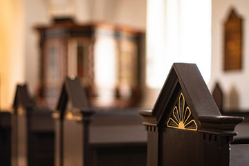 Closeup of benches, holy books and the churchroom of an Scandinavian chruch
