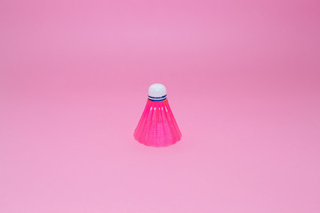 Pink badminton shuttlecock   isolated on the pink background. Concept sport , play, teamwork, motivation, attitude