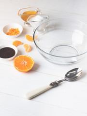 Cooking dessert ingredients with chia, milk and citrus orange on white background. Recipe steps by steps concept.