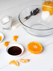 Cooking dessert ingredients with chia, milk and citrus orange on white background. Recipe steps by steps concept.