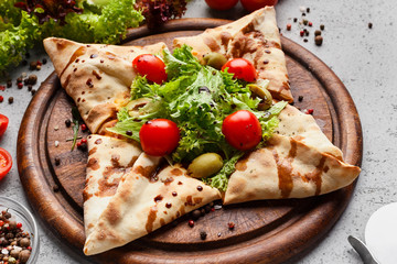 Star shaped pizza decorated with lettuce and cherry tomatoes
