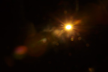 Abstract Natural Sun flare on the black background.