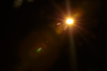 Abstract Natural Sun flare on the black background.