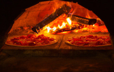 Italian pizza is cooked in wood-fired oven