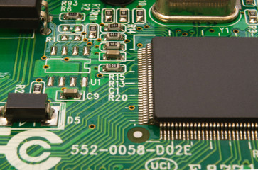 Electronic circuit board close up with different lighting.