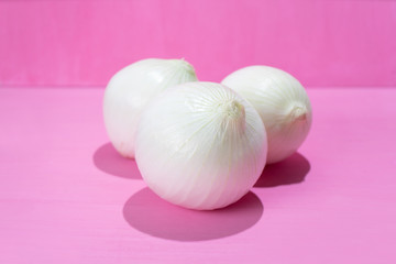 Fototapeta na wymiar Set of onions on colorful background