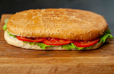 sandwich on a cutting board against a background of stone