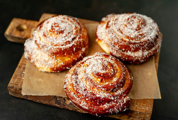 buns with pineapple filling on a cutting board on a background of concrete,Kanelbule - swedish dessert