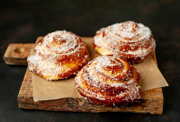 buns with pineapple filling on a cutting board on a background of concrete,Kanelbule - swedish dessert