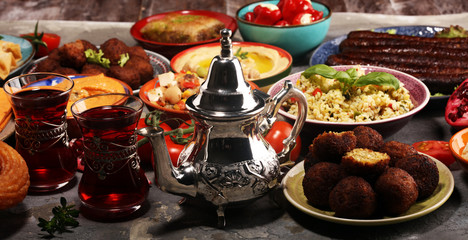 Middle eastern or arabic dishes and assorted meze, concrete rustic background. Falafel. Turkish...