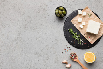 Block of butter and spices on concrete background