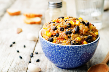 black beans, quinoa and corn chili on a wood background