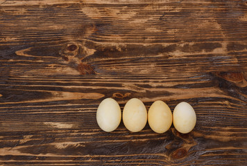 Easter background with easter eggs and spring flowers. Yellow eggs on gray background. Place for inscription. top view