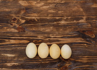 Easter background with easter eggs and spring flowers. Yellow eggs on gray background. Place for inscription. top view