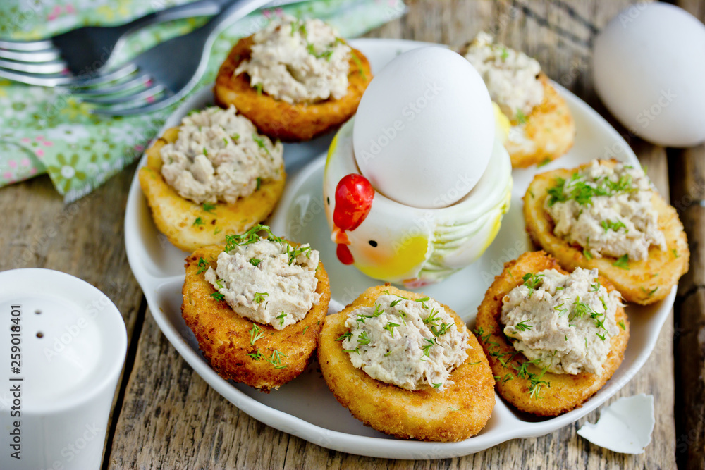 Wall mural Traditional Easter snack stuffed eggs deep fried and filled with tuna, yolk, dill and mayonnaise