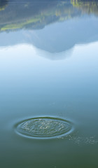 splash drops lake and Mount Txindoki reflected in the water, Basque Country