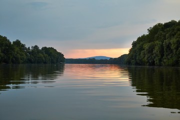 Peaceful waters of a river at sunset