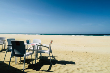 Coffee place with white chairs and table in a small town in southern spain, at the seaside of the mediterranean with sea view