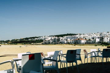 Coffee place with white chairs and table in a small town in southern spain, at the seaside of the mediterranean