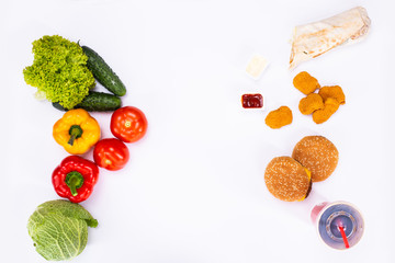 Concept of healthy and unhealthy food. Vegetables vs fast food, burgers, nagets and french fries isolated on white background