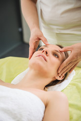 Fototapeta na wymiar Woman relaxing and enjoying during head massage