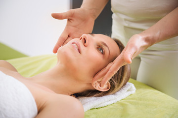 Fototapeta na wymiar Woman relaxing and enjoying during head massage