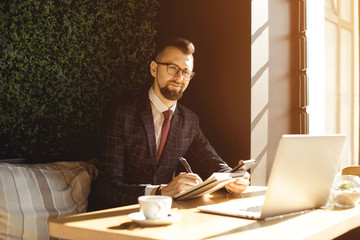 Young handsome businessman conducting negotiations with investors. Electronic business. Alternative...