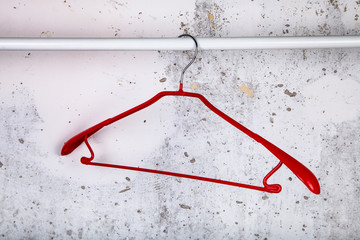 Red hanger on a gray wall