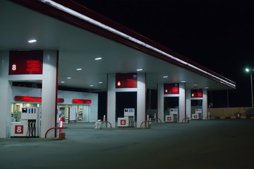 Illuminated gas station at night.