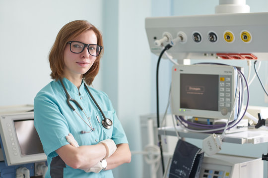 Smiling portrait of white redhead woman intensivist with stethoscope on neck in the icu