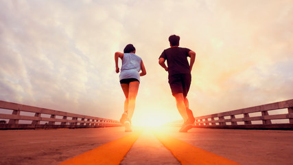Two runners ran outside. And running on jogging roads. The concept of creating good health