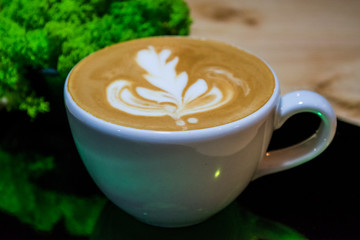 Cappuccino cup with latte art. Coffee with milk. Work barista. Fresh drink with caffeine.