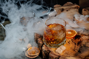 Alcohol cocktail with whiskey. Old Fashioned recipe ingredients on wooden board background. - 259029687