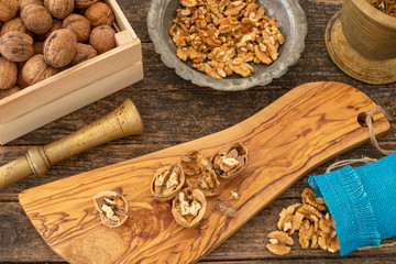 Many walnuts on the rustic table and in the shopping bag