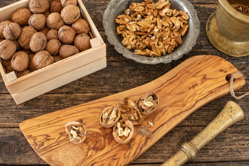 Many walnuts on the rustic table and in the shopping bag