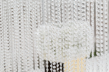 Crystal decorations for the wedding ceremony, luxurious decor. Beautiful arch decorated with chains with transparent beads