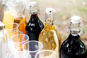Bottles with different drinks in outdoor buffet.