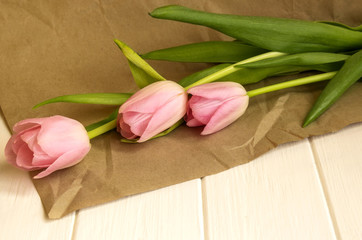 Bouquet of pink tulips on craft paper