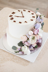 The newlyweds, the bride and groom, cut the wedding cake at the banquet.