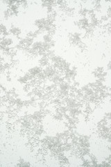 Ice on the glass, frozen patterns, white background.